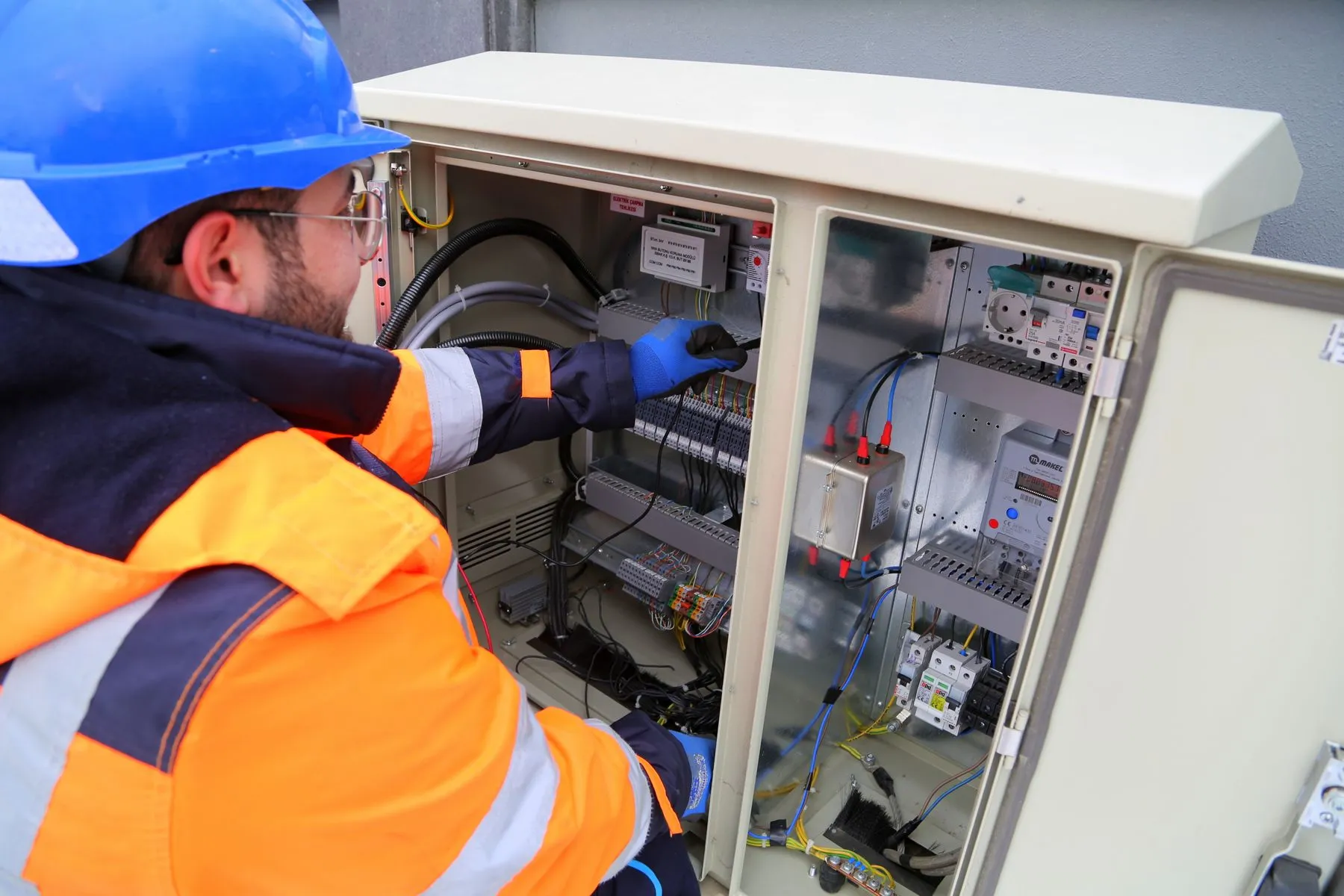 A Midwest Systems specialist working inside an industrial electrical panel