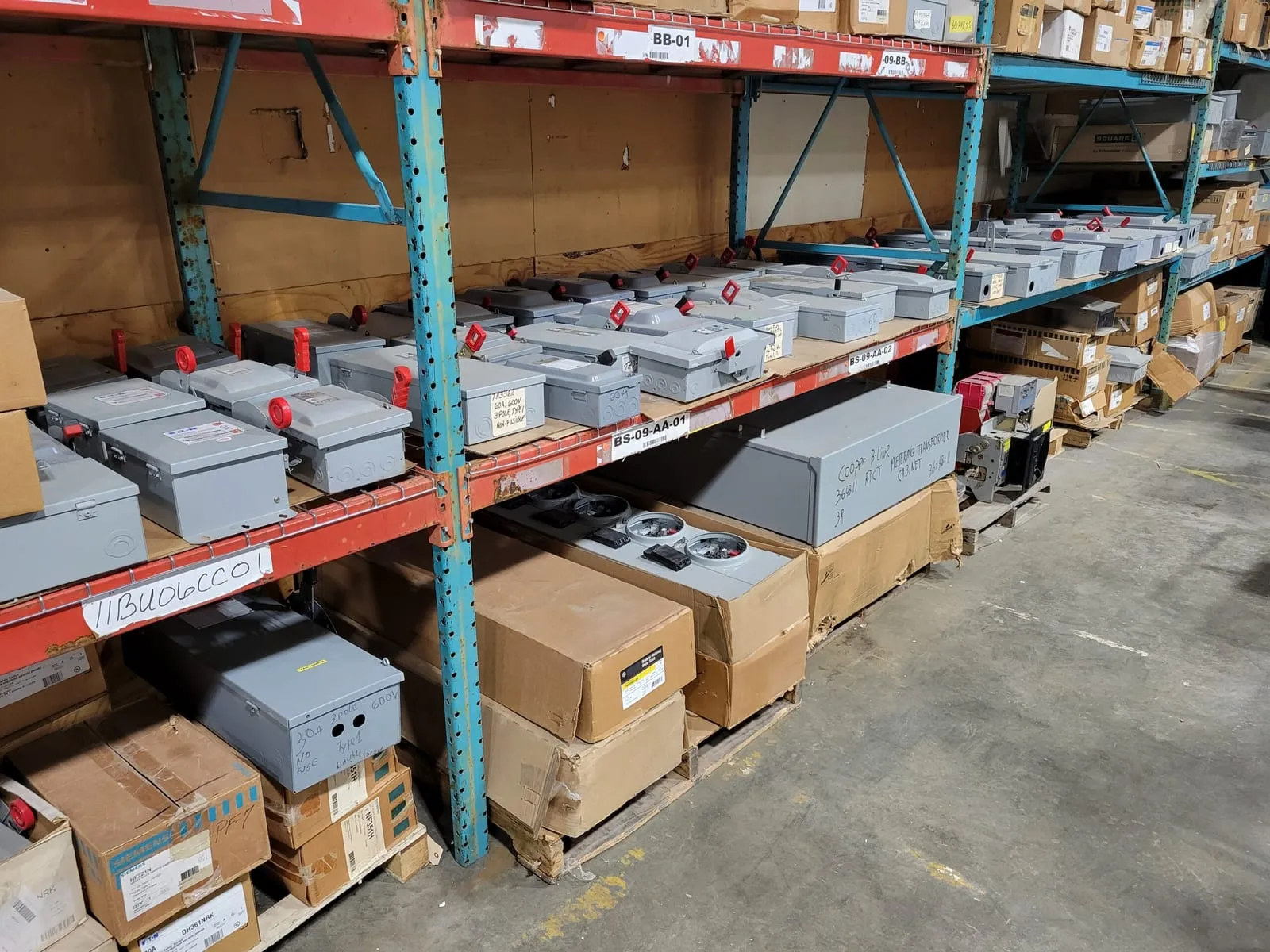Safety disconnect switches and breaker enclosures on labelled pallet racking in the Midwest Systems warehouse